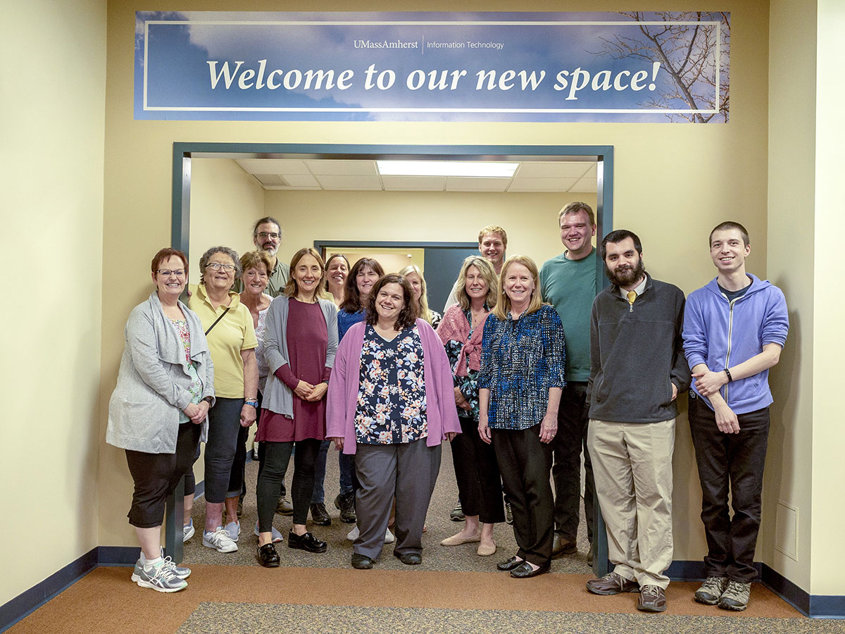group photo in front of building entrance with welcome banner