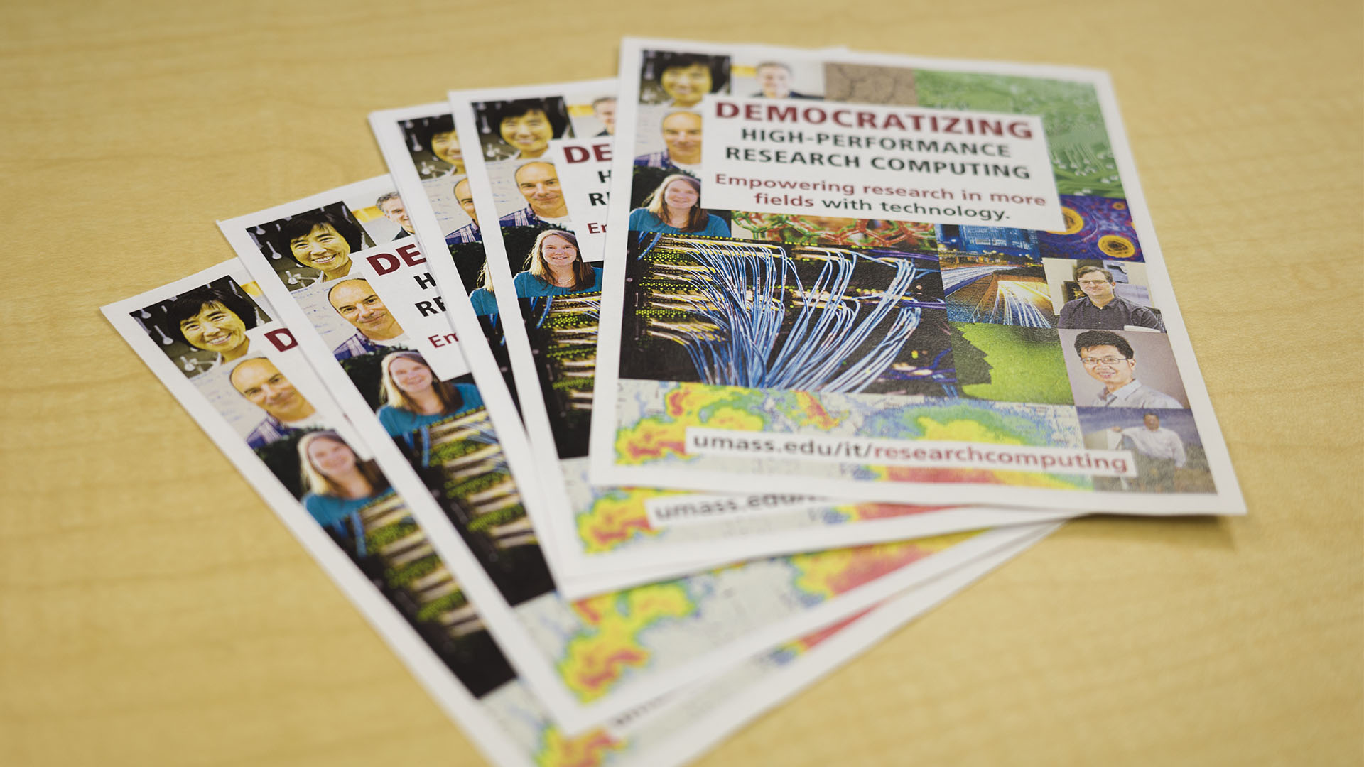 A stack of quarter page sized handout versions of the poster